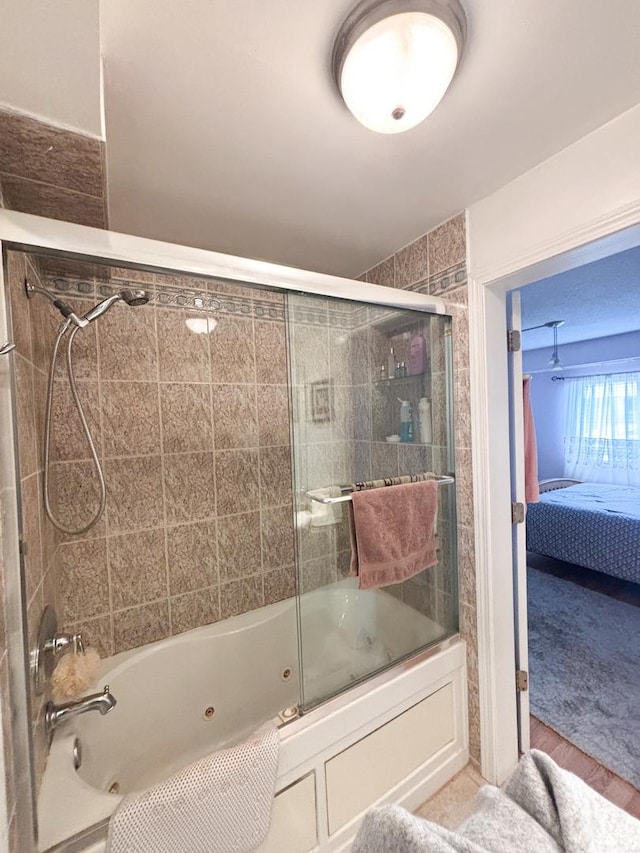 5500 Lincoln Ave Ave Unit 118E, Morton Grove, IL 60053 - ensuite bathroom featuring a combined bath / shower with jetted tub and wood finished floors