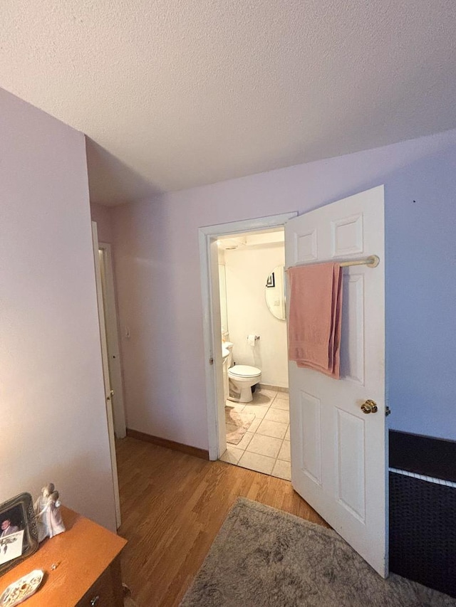 5500 Lincoln Ave Ave Unit 118E, Morton Grove, IL 60053 - hallway featuring light wood-style floors and a textured ceiling