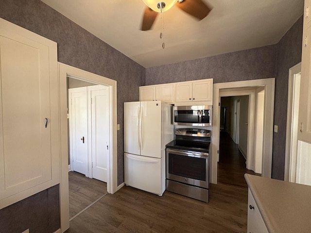 529 Pearl St, Ottawa, IL 61350 - kitchen featuring white cabinetry, stainless steel appliances, dark wood finished floors, wallpapered walls, and ceiling fan