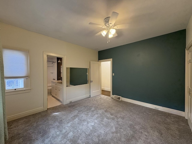 529 Pearl St, Ottawa, IL 61350 - unfurnished bedroom featuring visible vents, baseboards, connected bathroom, a ceiling fan, and carpet floors