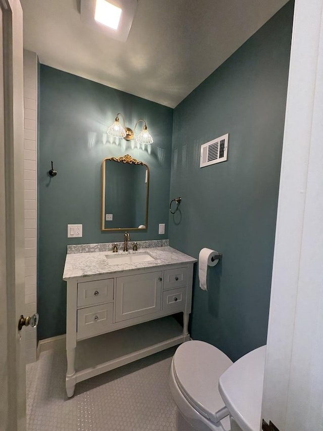 529 Pearl St, Ottawa, IL 61350 - bathroom with tile patterned floors, visible vents, toilet, and vanity
