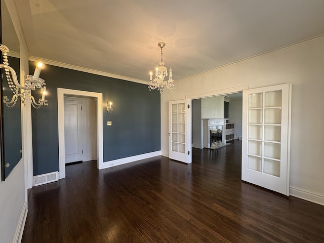 529 Pearl St, Ottawa, IL 61350 - unfurnished room featuring wood finished floors, a notable chandelier, baseboards, and visible vents