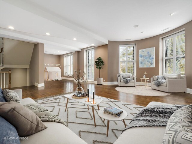 living room featuring baseboards, visible vents, wood finished floors, and recessed lighting