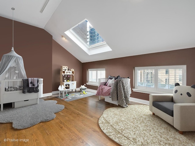 game room with baseboards, wood finished floors, and lofted ceiling with skylight