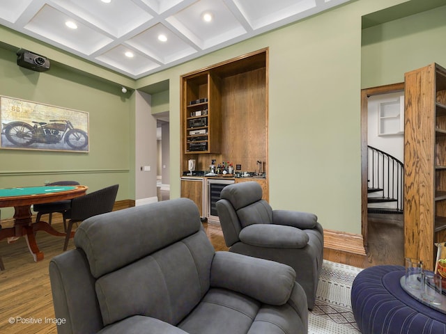 living room with wood finished floors, wine cooler, stairway, indoor wet bar, and coffered ceiling
