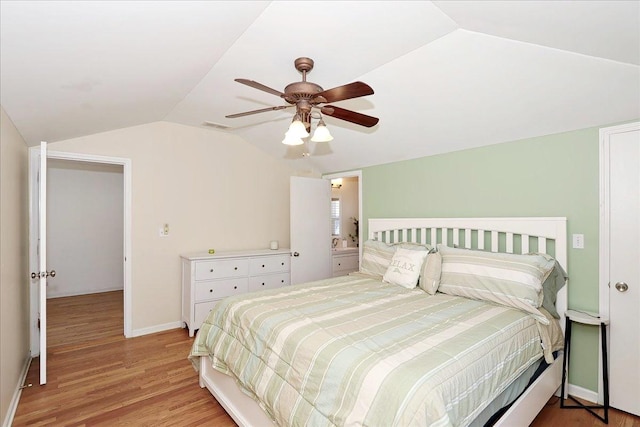 bedroom with light wood-type flooring, a ceiling fan, visible vents, vaulted ceiling, and baseboards