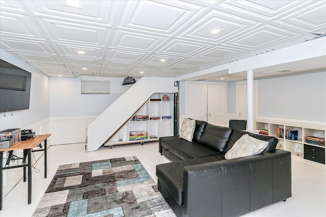 living room with recessed lighting, a wainscoted wall, stairs, and an ornate ceiling
