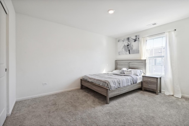 carpeted bedroom with baseboards and visible vents