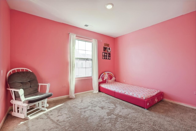 bedroom featuring baseboards, carpet flooring, and visible vents