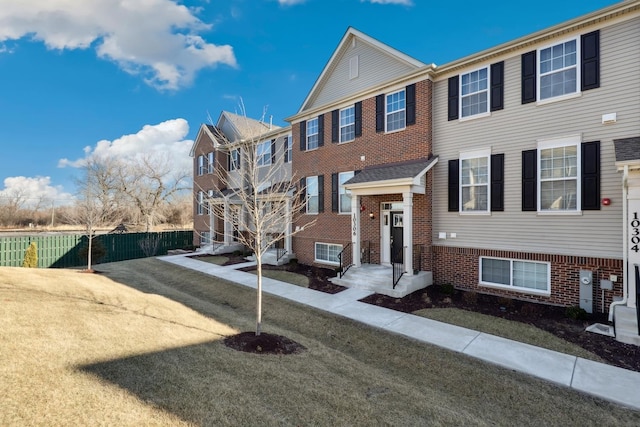 multi unit property with brick siding and fence