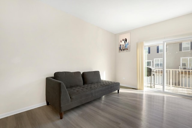 living area featuring baseboards and wood finished floors