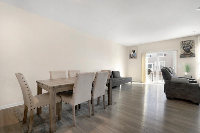 dining area with baseboards and wood finished floors