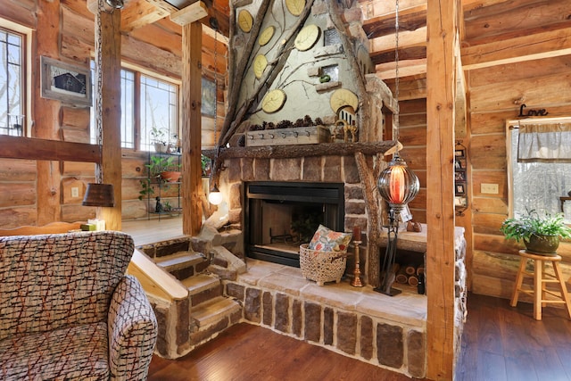 2655 County Road 550 E, Mahomet, IL 61853 - living area with log walls, a wealth of natural light, and hardwood / wood-style flooring
