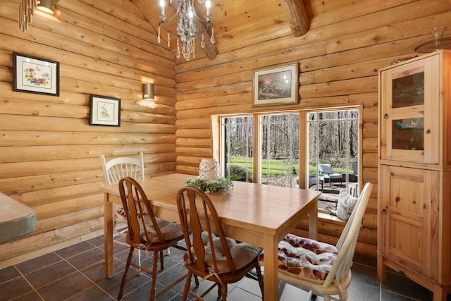2655 County Road 550 E, Mahomet, IL 61853 - dining space featuring rustic walls, high vaulted ceiling, an inviting chandelier, and dark tile patterned floors