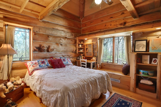 2655 County Road 550 E, Mahomet, IL 61853 - bedroom featuring wood-type flooring, beam ceiling, multiple windows, and visible vents