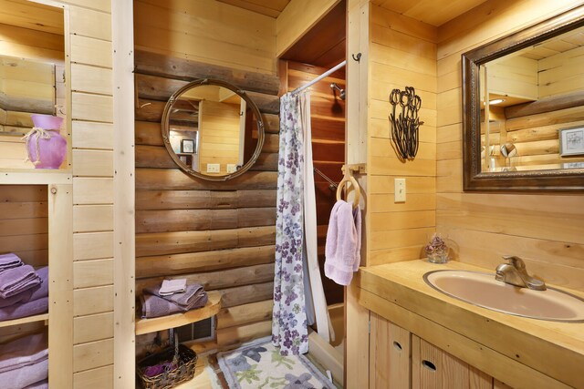2655 County Road 550 E, Mahomet, IL 61853 - full bath featuring log walls, vanity, and a shower with curtain