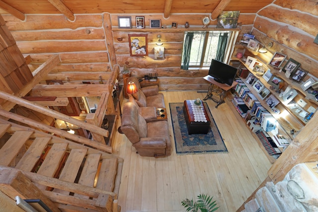 2655 County Road 550 E, Mahomet, IL 61853 - living room featuring log walls, beam ceiling, and wood finished floors