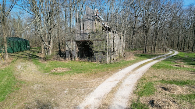 2655 County Road 550 E, Mahomet, IL 61853 - view of street featuring a wooded view and a barn