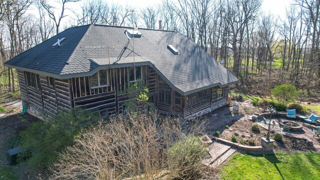 2655 County Road 550 E, Mahomet, IL 61853 - back of house with a sunroom, an outdoor fire pit, and roof with shingles