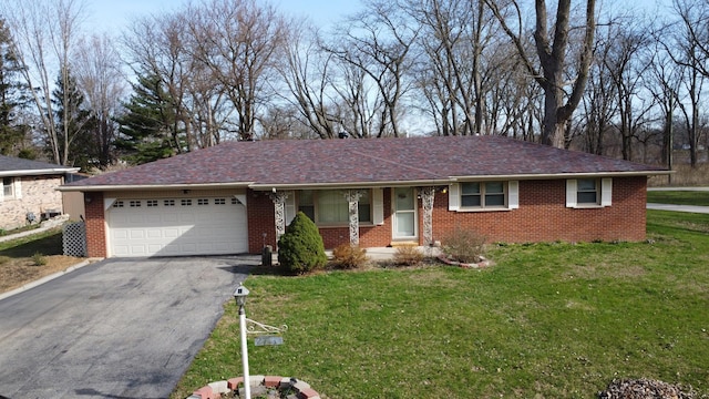 2775 E Riverview Dr, Kankakee, IL 60901 - ranch-style home with driveway, brick siding, a garage, and a front lawn
