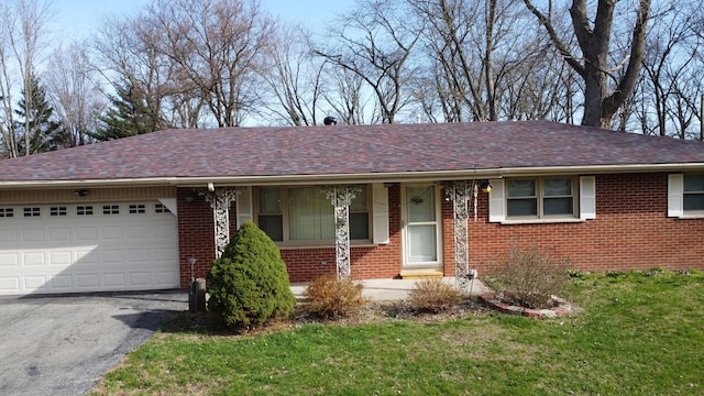 2775 E Riverview Dr, Kankakee, IL 60901 - ranch-style house with driveway, brick siding, a garage, and roof with shingles