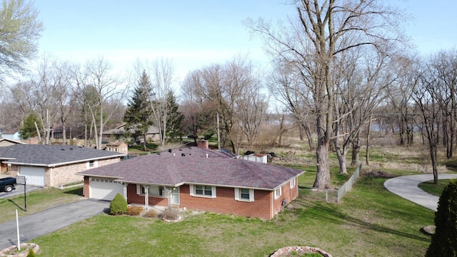 2775 E Riverview Dr, Kankakee, IL 60901 - exterior space with driveway, a front yard, an attached garage, and brick siding