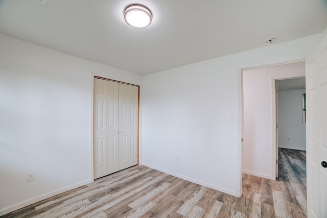 2775 E Riverview Dr, Kankakee, IL 60901 - unfurnished bedroom with a closet, baseboards, and wood finished floors
