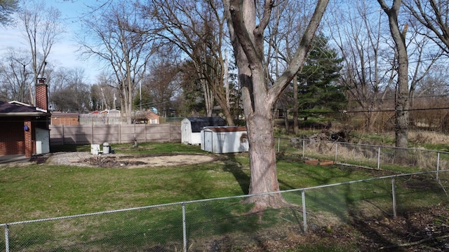 2775 E Riverview Dr, Kankakee, IL 60901 - view of yard with an outdoor structure, a fenced backyard, and a storage shed