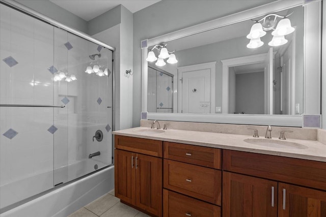 full bathroom with an inviting chandelier, tile patterned floors, a sink, and double vanity
