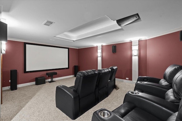 cinema room featuring carpet floors, a raised ceiling, baseboards, visible vents, and ornamental molding