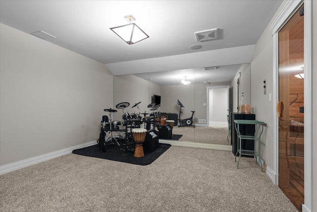 exercise area featuring carpet, baseboards, and visible vents