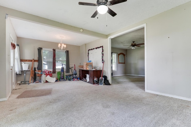 201 E Boundary St, Stanford, IL 61774 - carpeted living room featuring plenty of natural light, a ceiling fan, a chandelier, and baseboards