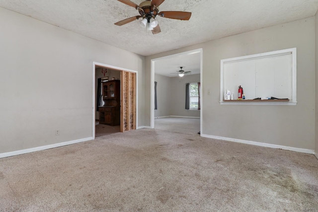 201 E Boundary St, Stanford, IL 61774 - unfurnished room with a ceiling fan, carpet flooring, baseboards, and a textured ceiling