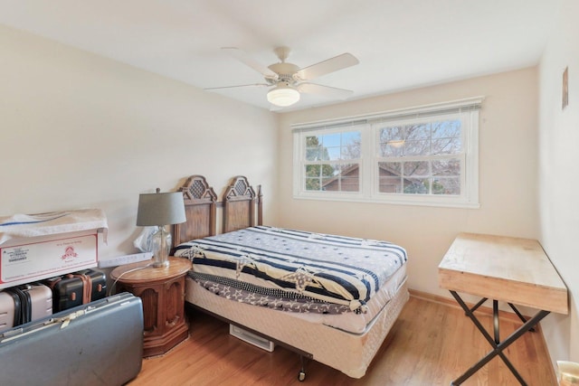 bedroom with wood finished floors and ceiling fan