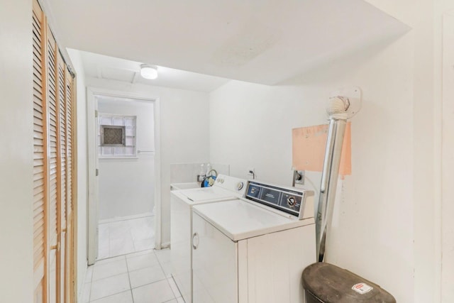clothes washing area featuring laundry area, separate washer and dryer, and light tile patterned flooring