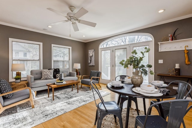 dining area with light wood finished floors, a ceiling fan, recessed lighting, and crown molding