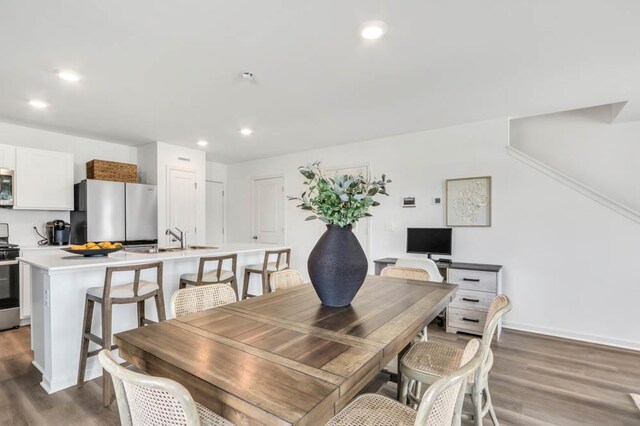 dining area with recessed lighting, baseboards, and wood finished floors