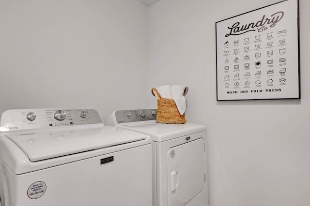 laundry room with washing machine and clothes dryer and laundry area