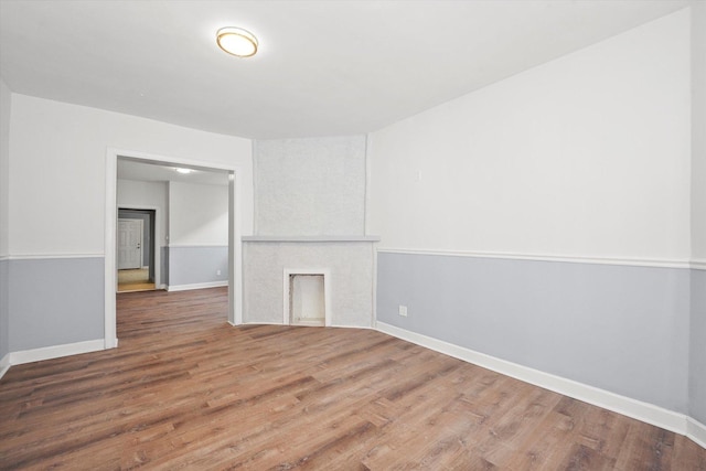 unfurnished room featuring baseboards and wood finished floors