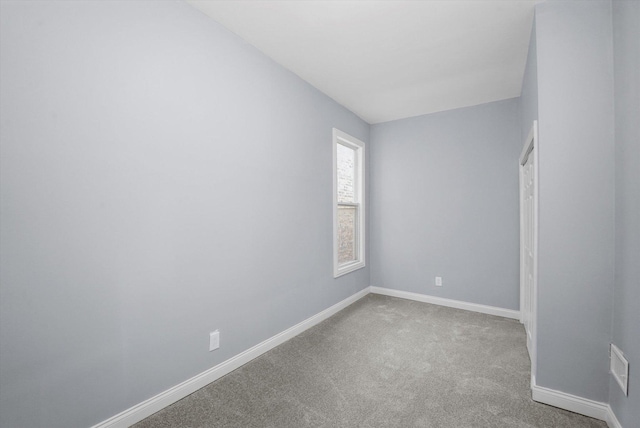 carpeted empty room with baseboards and visible vents