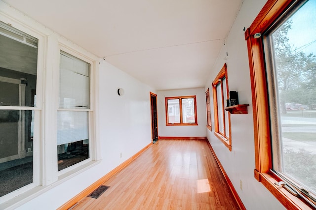 245 E 4th Ave, Clifton, IL 60927 - unfurnished sunroom with visible vents, baseboards, and wood finished floors