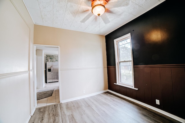 245 E 4th Ave, Clifton, IL 60927 - unfurnished room featuring a wainscoted wall, ceiling fan, and wood finished floors