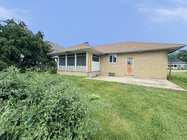 321 1st St, Bradford, IL 61421 - back of property with a sunroom, a lawn, a patio area, and brick siding