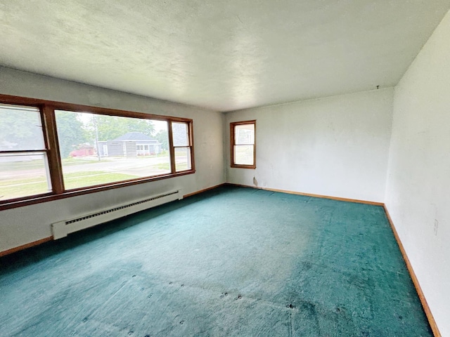 321 1st St, Bradford, IL 61421 - unfurnished room featuring a baseboard radiator and carpet flooring