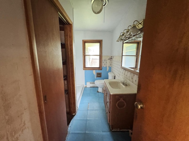 321 1st St, Bradford, IL 61421 - bathroom featuring vanity, a baseboard heating unit, a wainscoted wall, and tile patterned floors