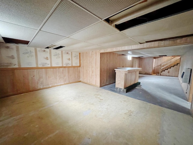321 1st St, Bradford, IL 61421 - finished below grade area featuring a paneled ceiling, a dry bar, stairs, and wooden walls