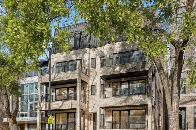 back of property featuring brick siding