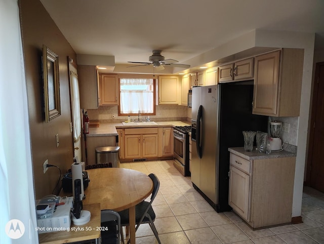 8550 S Avalon Ave, Chicago, IL 60619 - kitchen featuring appliances with stainless steel finishes, a sink, a ceiling fan, and light tile patterned flooring