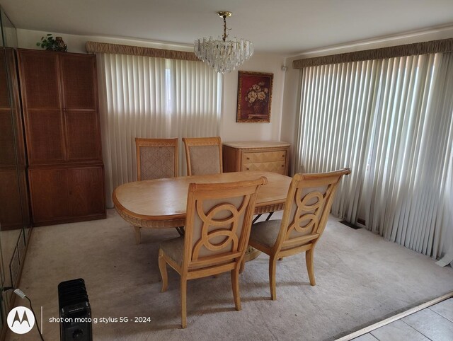 8550 S Avalon Ave, Chicago, IL 60619 - dining room featuring a chandelier, light colored carpet, and plenty of natural light