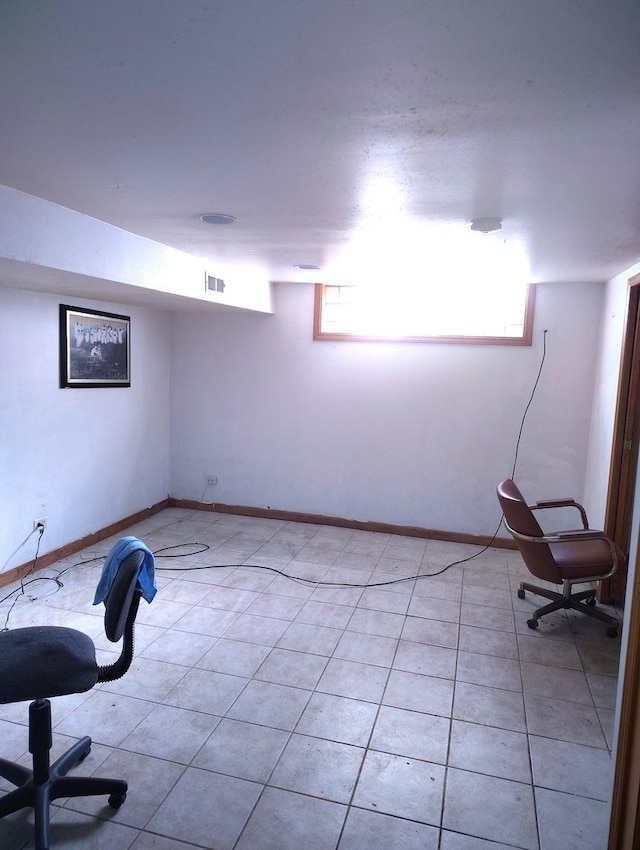 8550 S Avalon Ave, Chicago, IL 60619 - below grade area with baseboards and light tile patterned flooring